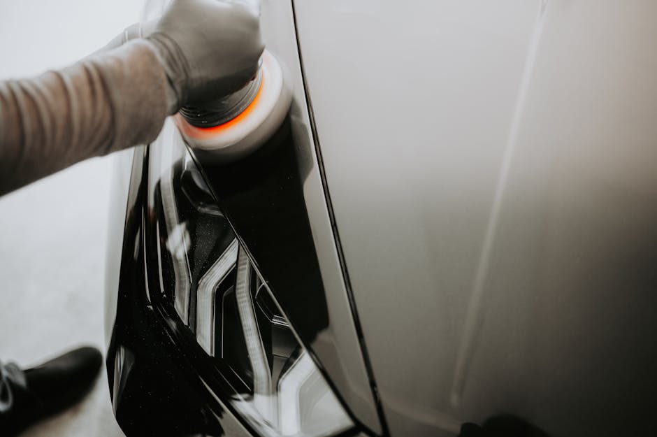 Professional polishing the exterior of a car